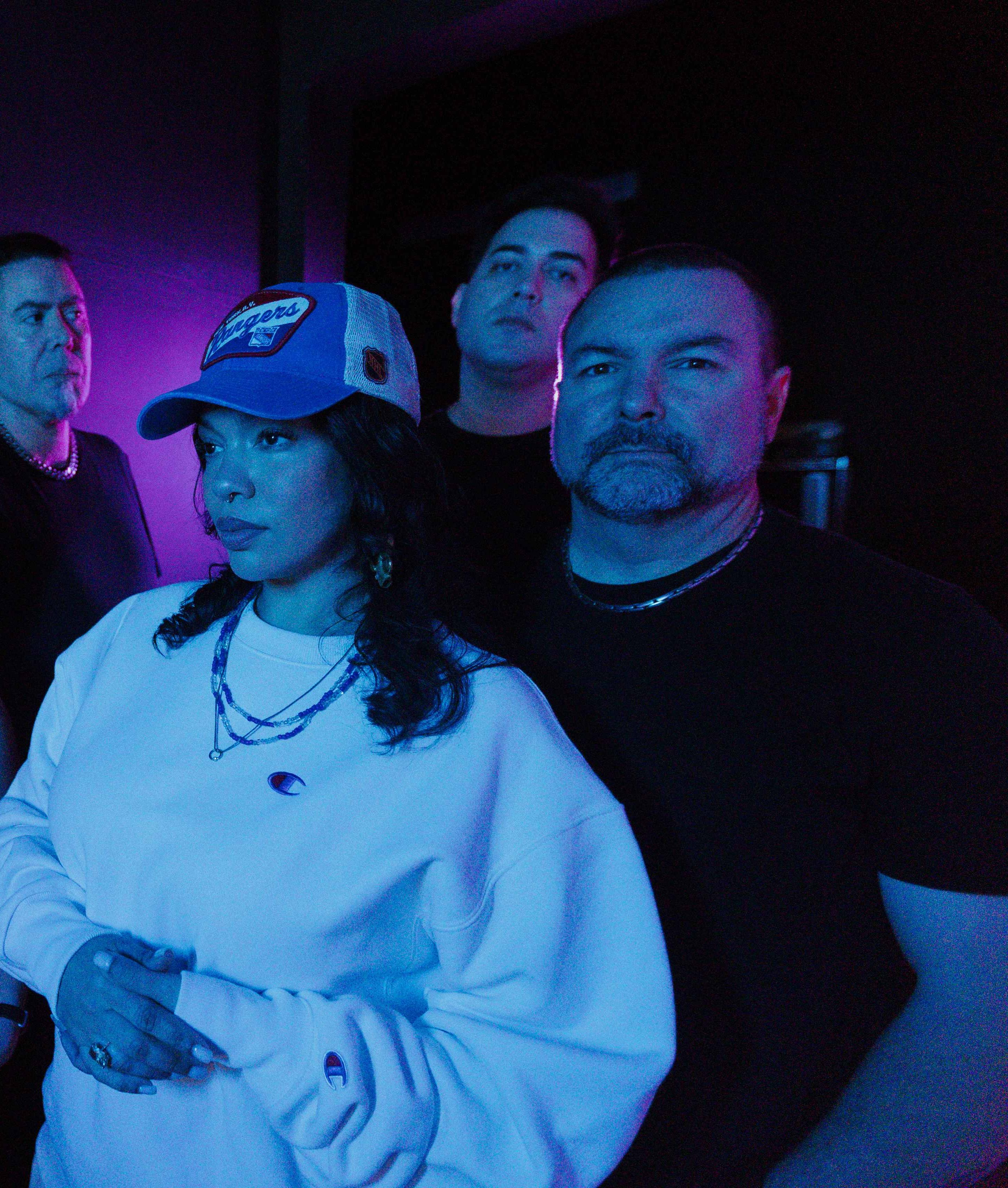 Diablura, the four-piece heavy metal band, lit in purple and blue neon